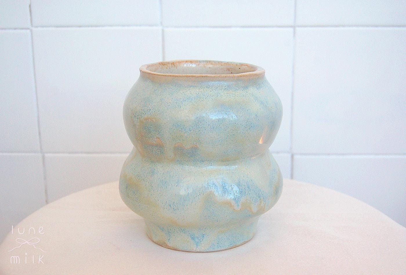 Organic wavy ceramic vase natural stoneware pastel ice blue turquoise variegated and speckled cream glossy glaze, handmade high temperature