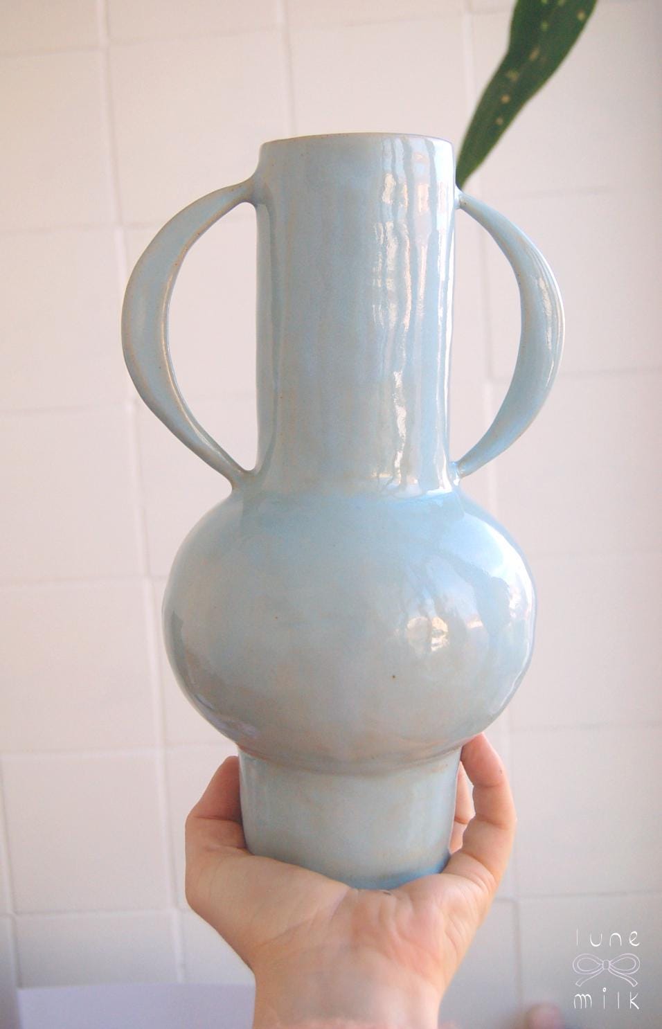 Organic winged ceramic vase natural stoneware glossy pastel blue glaze with semi-circular handles, handmade high temperature