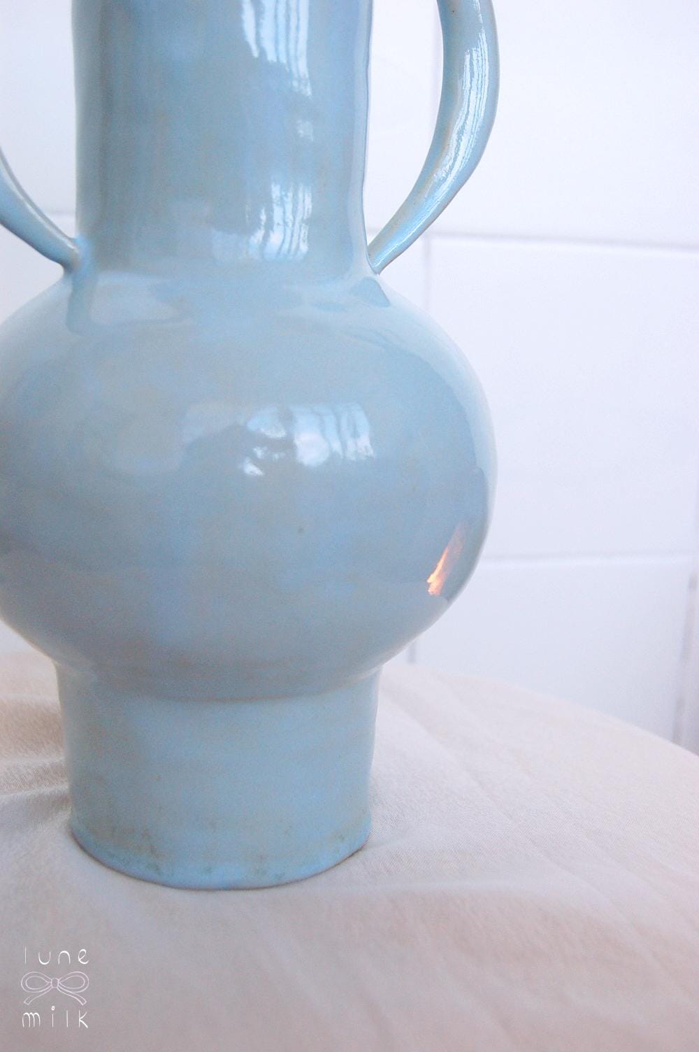 Organic winged ceramic vase natural stoneware glossy pastel blue glaze with semi-circular handles, handmade high temperature