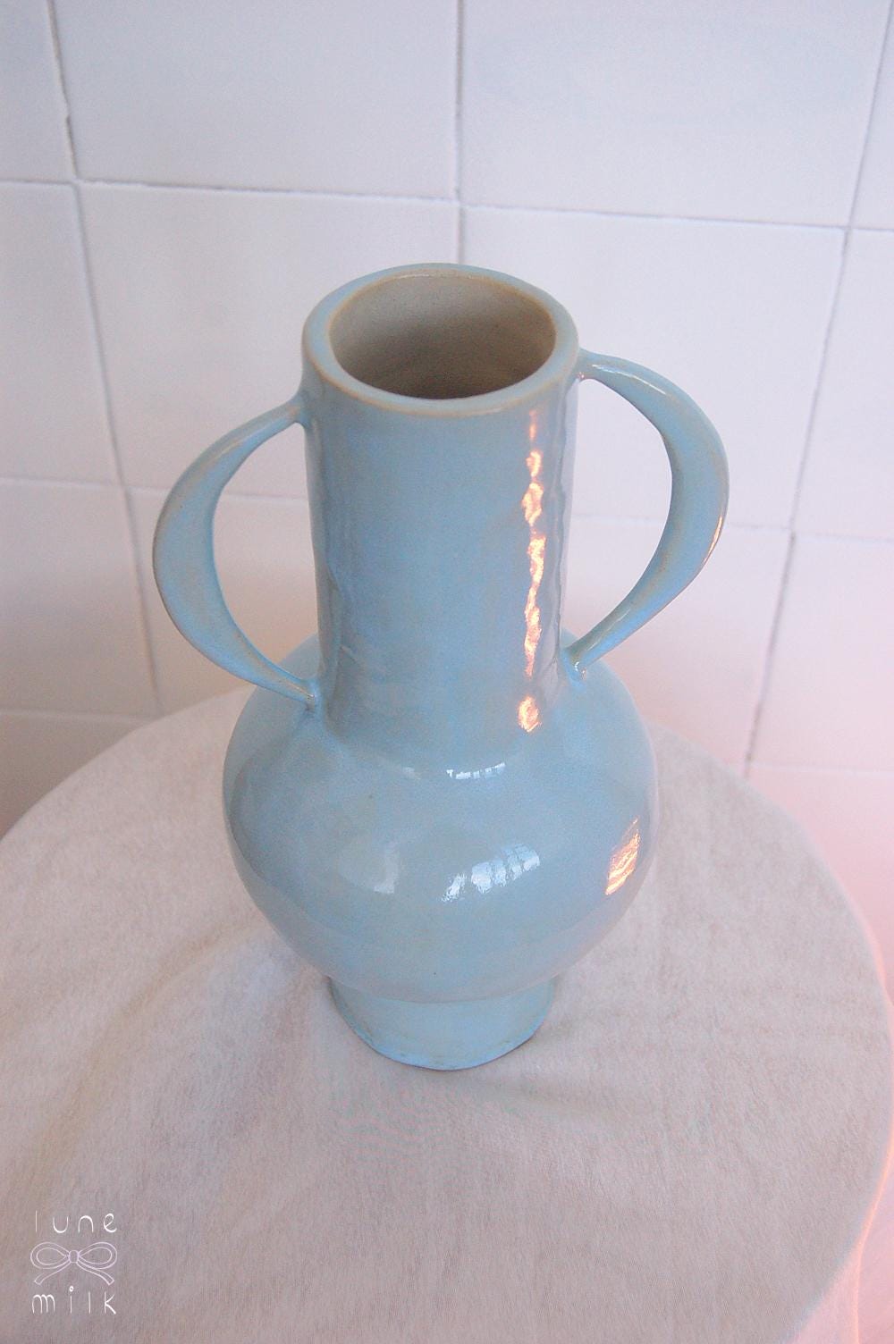 Organic winged ceramic vase natural stoneware glossy pastel blue glaze with semi-circular handles, handmade high temperature