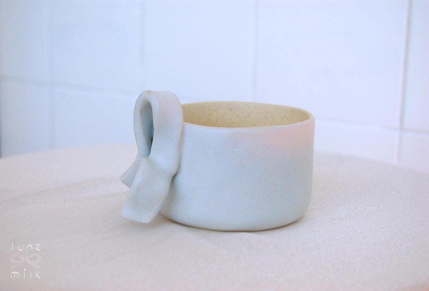 Mug cappuccino organic natural stoneware pastel blue and speckled sand color glazes, handmade wheel thrown with ribbon handle